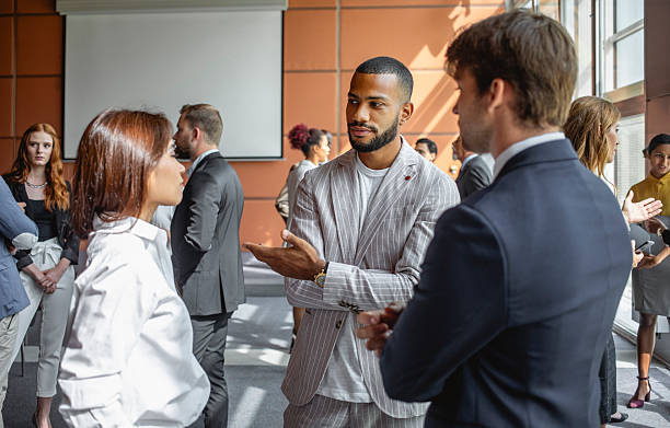 istock Diverse Executives Engaging in Conversations at Business Conference 2228461910