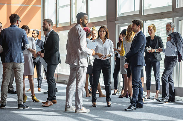 istock Diverse Business Executives Networking at Sunlit Conference Venue 2228461921