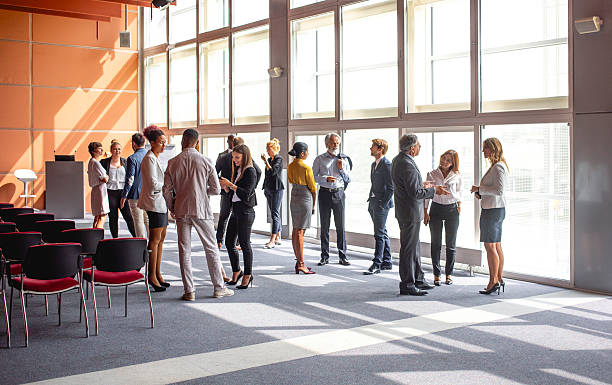 istock Diverse Business Executives Interacting at a Conference in a Sunlit Room 2228461989