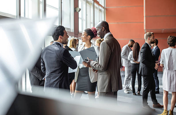 istock Diverse Business Professionals Engaging in Conversations at a Conference 2228462003