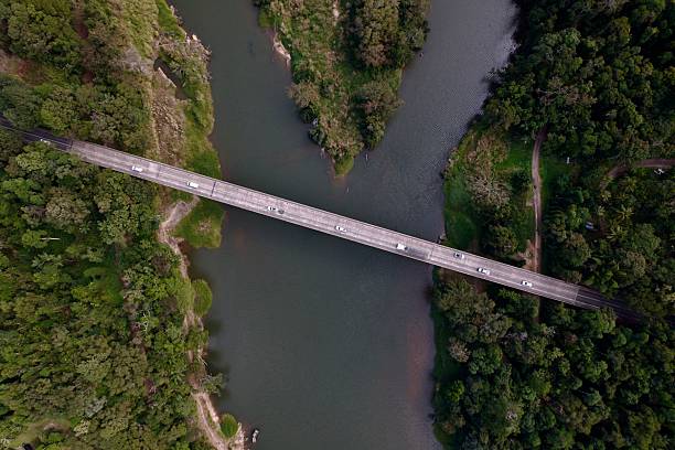 istock Aerial view of a bridge over a river with lush forest. 2228462841