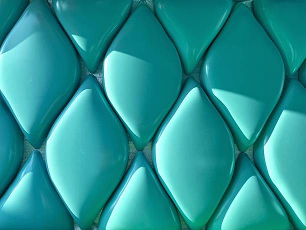 istock A textured background showcases a seamless pattern of raised, teal-colored, diamond shapes.
Concept of: Modern, geometric design. 2228464984