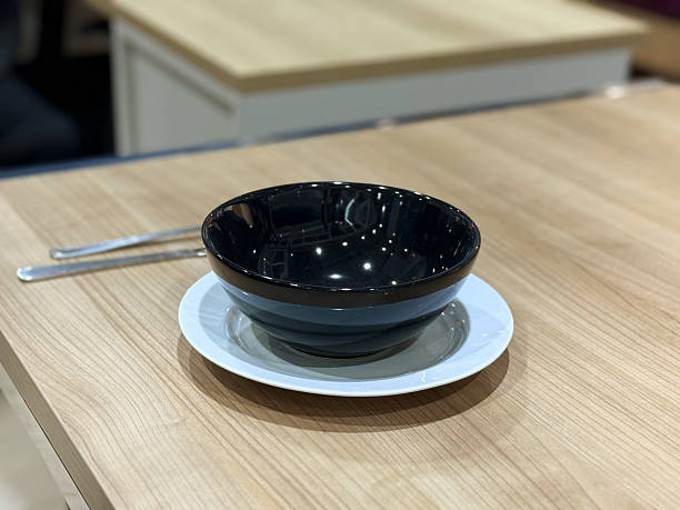 istock Empty ceramic bowl on a wooden table in a restaurant, stock photo 2228465434
