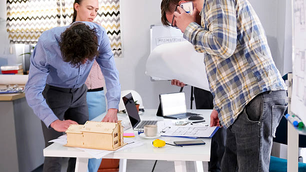 istock A team of young designers is working on creating a smart home model. A group of architects discusses the details of the project 2228468679