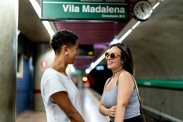 istock Lesbian couple talking on the subway station 2228469584