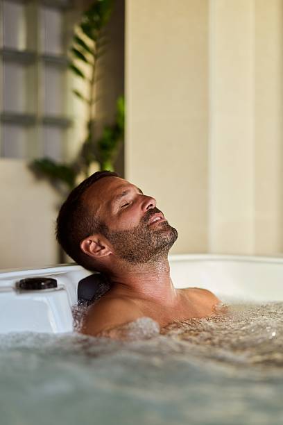 istock Relaxed Man Enjoying a Hot Tub Experience Indoors During Daytime 2228469879