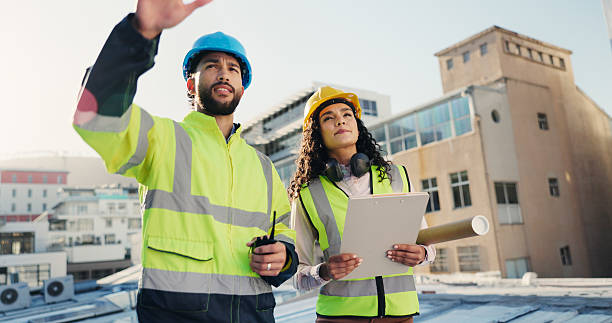 istock Building, clipboard and collaboration with people on rooftop together for construction or planning. Blueprint, conversation and infrastructure with architect team in city for engineering development 2228476368
