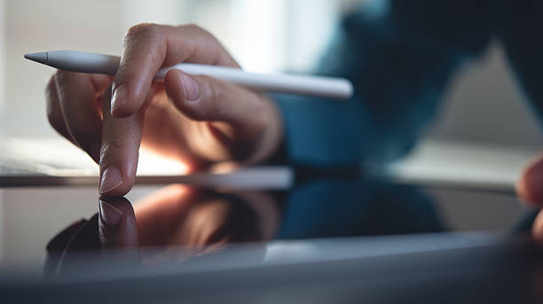 istock Close up, business man working on digital tablet, touching on the screen, reading e-document before signing with stylus pen. Graphic designer using graphic tablet and electronic pen 2228476827