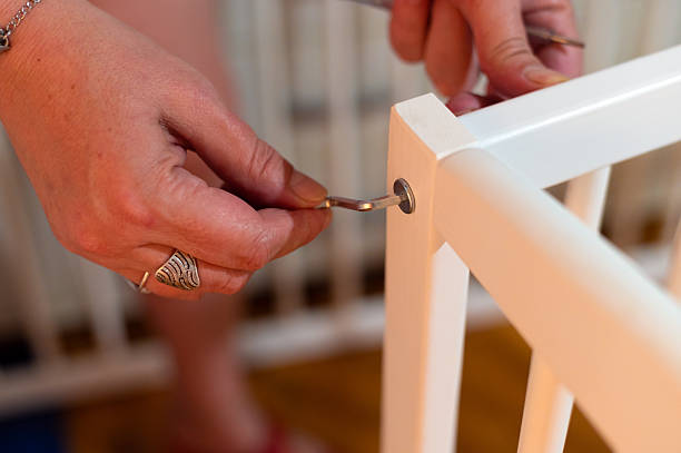 istock Grandmother assembling wooden cradle for her grandchild 2228477909