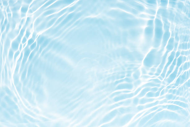istock Blue water with ripples on the surface. Defocus blurred transparent blue colored clear calm water surface texture with splashes and bubbles. Water waves with shining pattern texture background. 2228479063