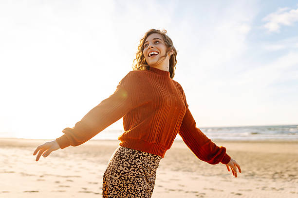 istock Joyful woman in hat having fun and walking on sunny beach. 2228483548