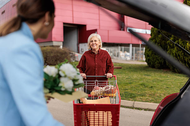 istock Mother and Daughter Loading Groceries into Car After Shopping 2228485428