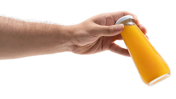 istock Hand holding a bottle of fresh orange juice 2228487671