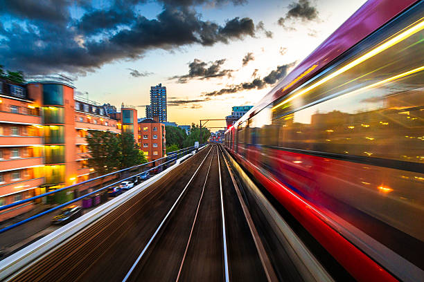 istock Blurred motion of passenger train speeding through city at twilight 2228488148