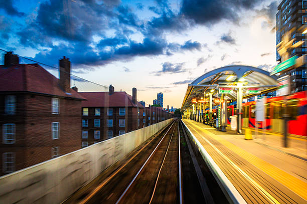Long exposure shot depicting the blurred motion of railroad tracks as viewed from a passenger train as it speeds through the city.