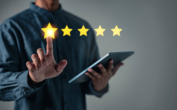 istock Customer satisfaction is key as a businessman adds a five star rating indicating best business rates, aiming to increase the company standing in the eyes of the customer 2228488770