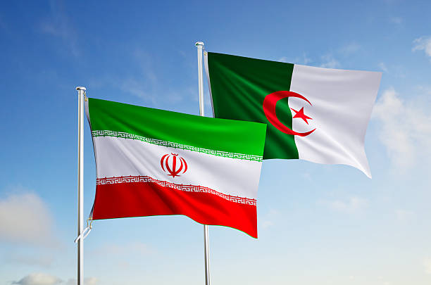 istock flags of  algeria and iran over blue sky background. 2228490680