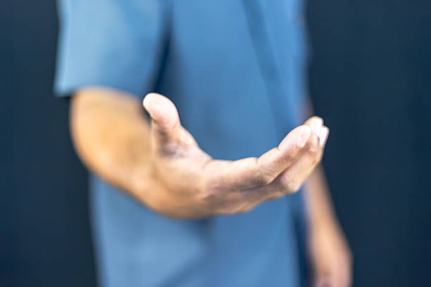 Two hands are almost touching for handshake in silhouette
