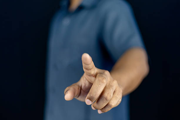 A man's hand shows a finger up