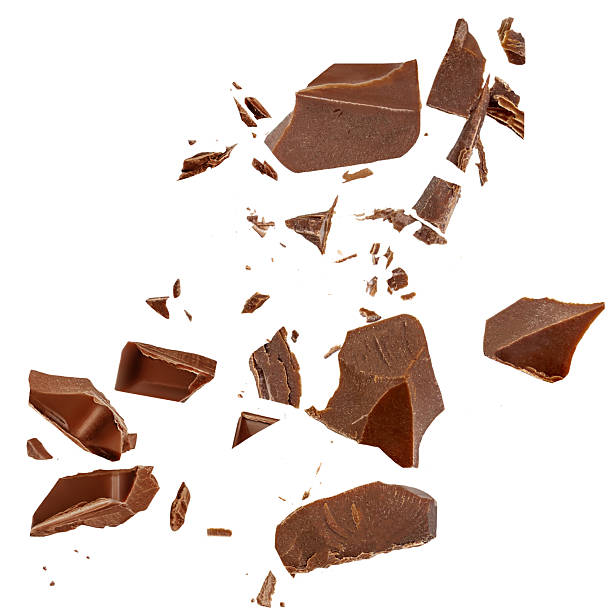 istock Chocolate explosion isolated on white. Broken chocolate bar pieces flying in the air. Top view. Flat lay. Chocolate levitation with scattered cocoa crumbs 2228495646