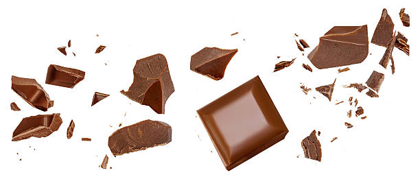 istock Chocolate explosion isolated on white. Broken chocolate bar pieces flying in the air. Top view. Flat lay. Chocolate levitation  2228495690