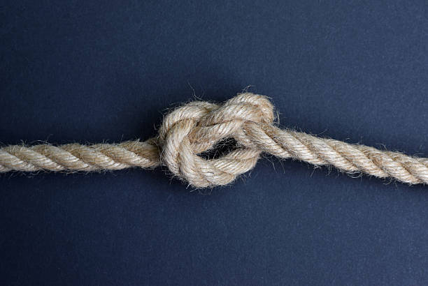 istock Thick rope knot on blue background. Hemp rope with knot. 2228497969