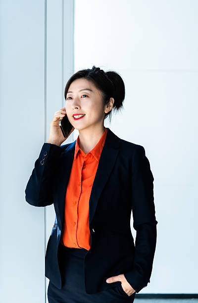 istock Businesswoman using smart phone near the window 2228499369