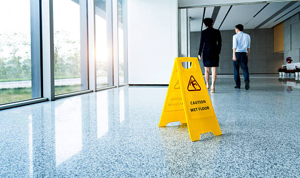 istock Caution wet floor sign with businessmen walking 2228499685