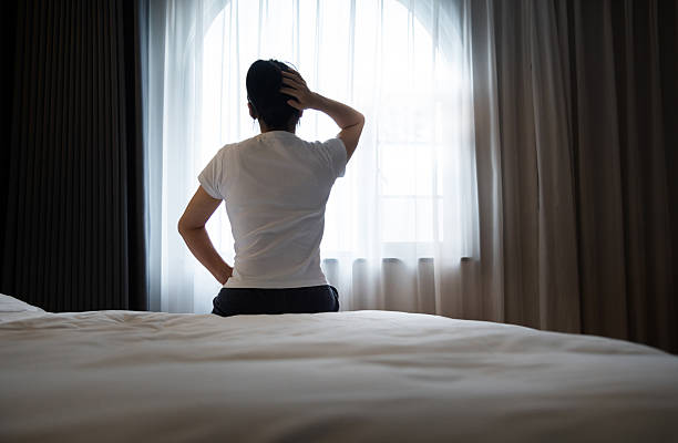 istock Woman waking up with headache 2228500910