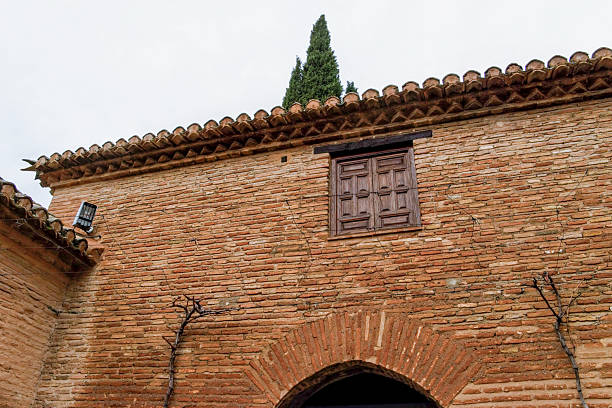 An old empty arch space for a statue in brick, plaster and marble, located outside the Roman Forum in central Rome.