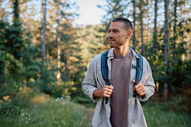 istock Young male hiker walking in forest enjoying nature 2228509769