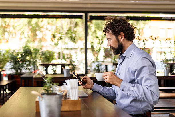 istock Businessman Typing on Laptop with Coffee Cup 2228511494