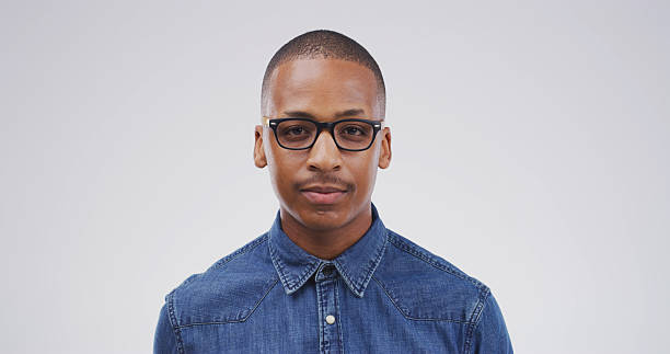 istock Portrait, confidence and creative black man in studio as event planner for business. African person, glasses and pride with worker, venue coordinator and about us on white background space in Kenya 2228512199
