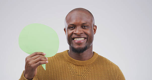 istock Happy, black man and portrait with speech bubble in studio for chat on a white background. Male person, feedback or model face with smile, icon or shape for quote, conversation or say on mockup space 2228512417