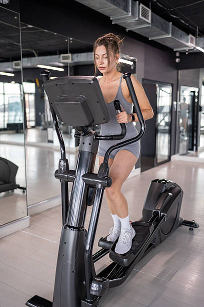 istock A woman is actively exercising on an elliptical machine at a modern gym facility 2228512442