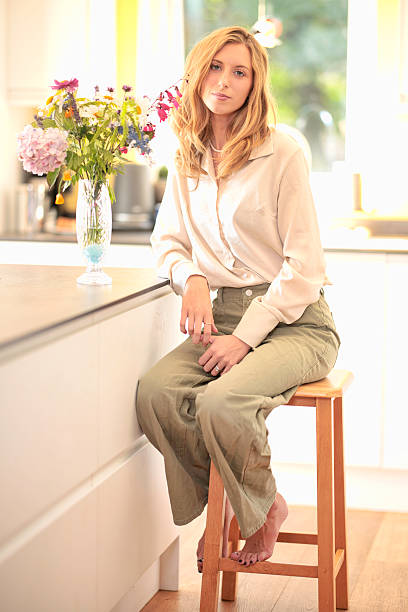 istock Smart casual young lady in her kitchen 2228512582