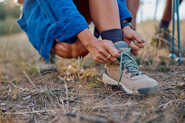 istock Hiker tying shoelaces on trekking boots, getting ready for adventure 2228512779