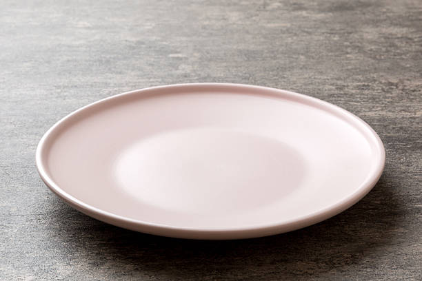 Perspective view of empty light plate on cement background. Empty space for your design