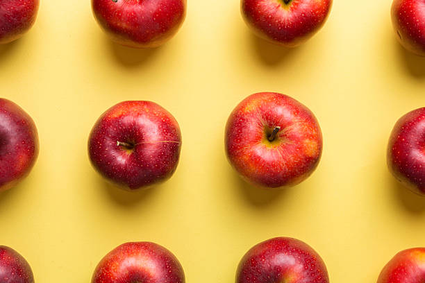 istock Many red apples on colored background, top view. Autumn pattern with fresh apple above view 2228513078