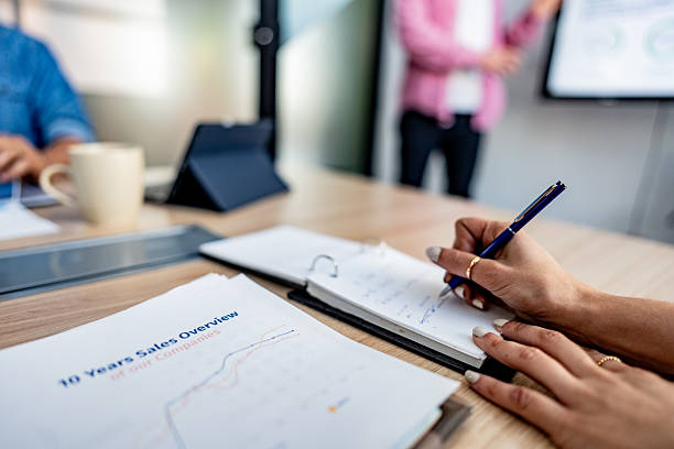 istock Close-up of woman taking notes during meeting at office 2228514582