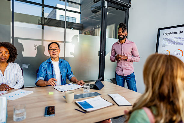 istock Young businessman talking to coworkers at office 2228514708