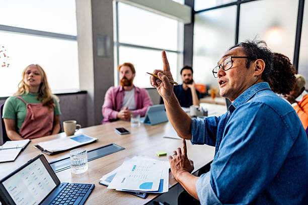 istock Mature businessman asking a question during meeting at office 2228514743