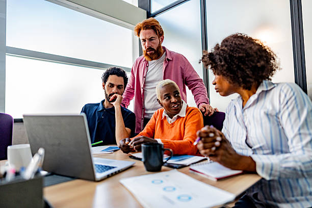 istock Coworkers talking during meeting at office 2228514796