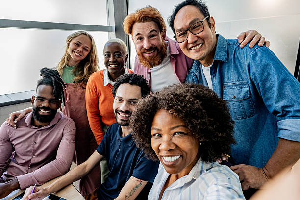 istock Coworkers taking a selfie at office - Camera point of view 2228514893