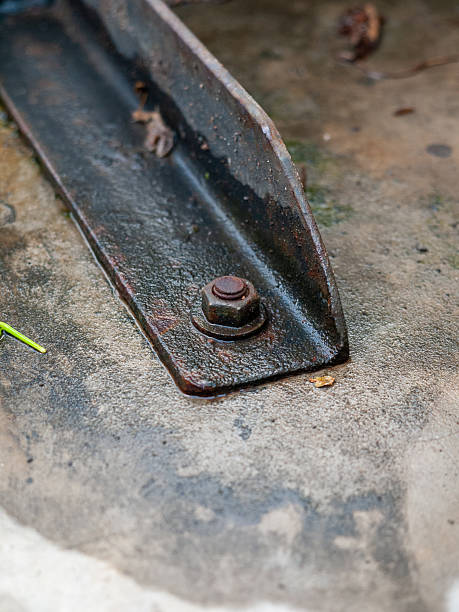 istock Close-up of a weathered steel beam with a rusted bolt on a textured surface. 2228514907