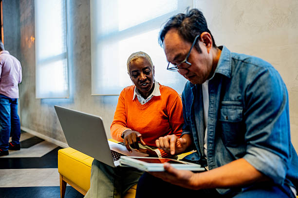istock Coworkers talking and using laptop at coworking 2228514920