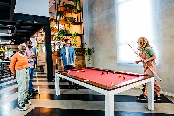 istock Coworkers playing snooker at modern office 2228515237