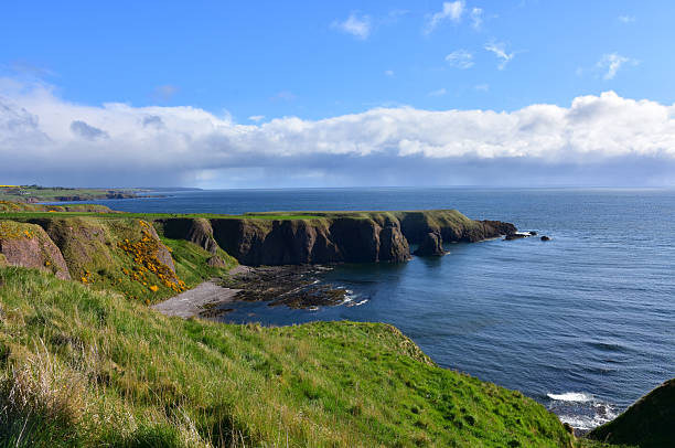 istock Rocky Sea Cliffs Towering Over a Bay in Scotland 2228515829