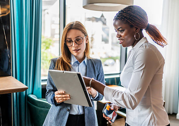 istock Businesswomen collaborating on digital tablet in modern office 2228517366