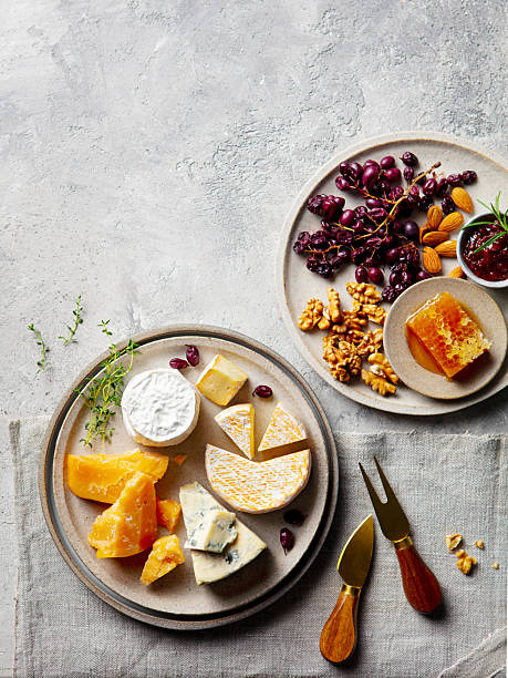 Cheese assortment on a platter. Dark background. Copy space. Top view.